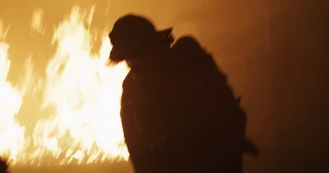 Firefighter in front of fire Stock Footage 91144619
