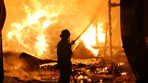 Firefighter In Front Of A Open Fire Stock Footage