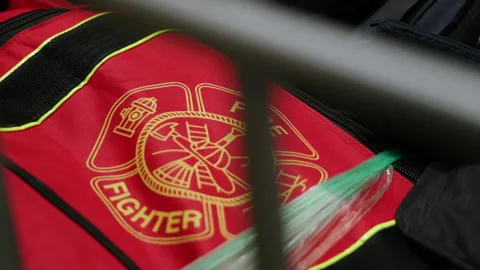 Firefighter gear in a bin waiting for use at a fire station Stock Footage 347214512