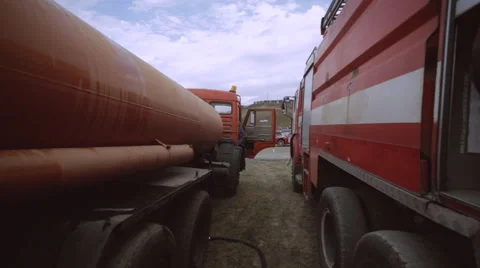 Firefighter goes between fire trucks Video stock 54935539