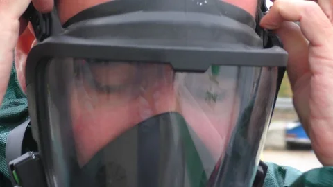 Firefighter of Haifa Chemicals is getting ready for action, wearing his gas mask Video stock 102980461