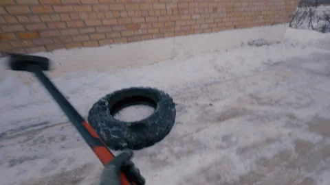 A firefighter hits a tire with a sledgehammer, combining different blows. Stock Footage 321858668