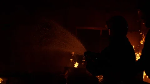 Firefighter with a house inside a burning house Video stock 283167002