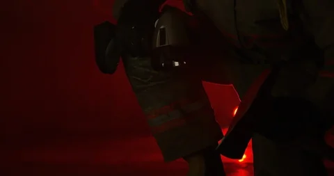 Firefighter on knees turns on flash light in confined space Stock Footage 108821684