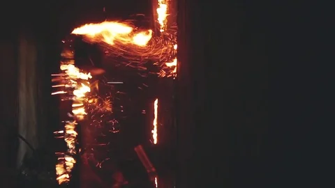 A firefighter knocks out the burning door Stock Footage 76850250