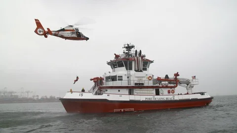 Firefighter landing on Fireboat deck through rope attach to flying helicopter Stock Footage 116474552