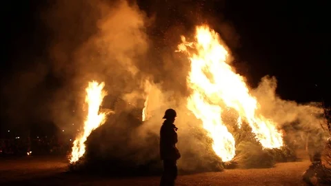 Firefighter lighting Christmas trees on fire Stock Footage 122306275