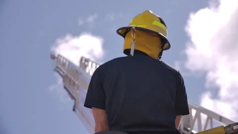 Firefighter looking at ladder on an engine Stock Footage 308319698