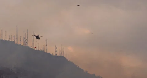 Firefighter Maneuvering in Wildfire Response Operation amidst the Hills Stock Footage 241179923