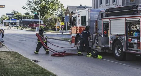 Firefighter moving hose Stock Photos