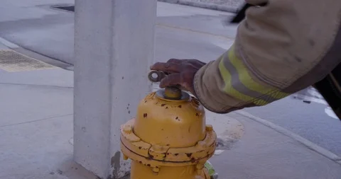 Firefighter opening a fire hydrant Stock Footage 107628037