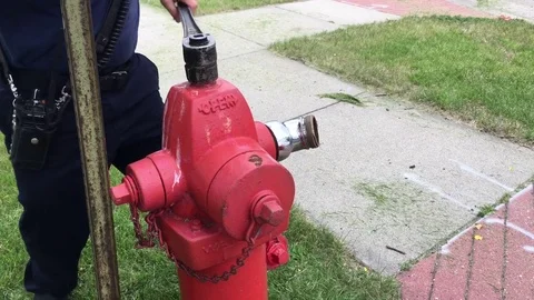 Firefighter Opening Hydrant with Rusty Water 스톡 동영상 77143792