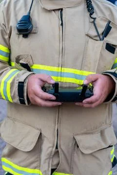 Firefighter operating drone in search and rescue. vertical photo Stock Photos