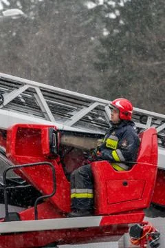 Firefighter operating extendable crane arm Stock Photos