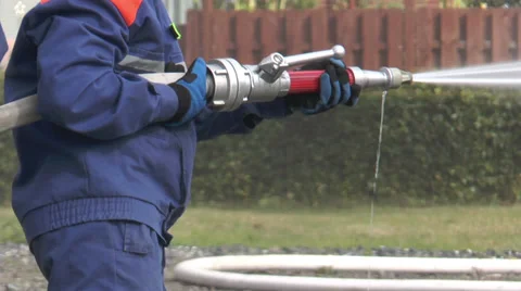 Firefighter operating fire hose Stock Footage 29668632