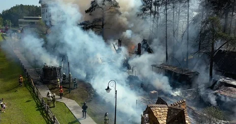 Firefighter or fireman extinguishes burning fire flame with smoke on home Video stock 113113145
