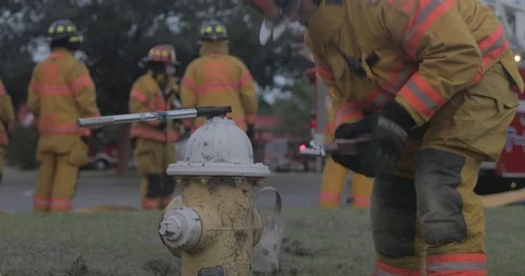 Firefighter places a piece of firefighting equipment to attach a fire hose Stock Footage 102420170
