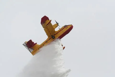 Firefighter Plane ejecting water load Stock Photos