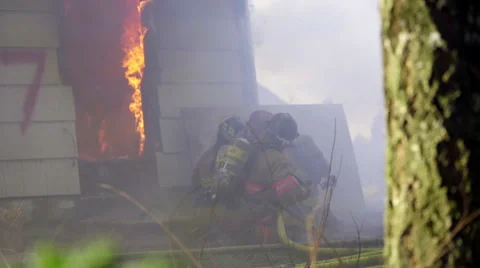 Firefighter points where to spray water Stock Footage 60761433