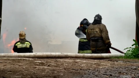 Firefighter poured over the head of a firefighter with water from a fire hose Stock Footage 109389022
