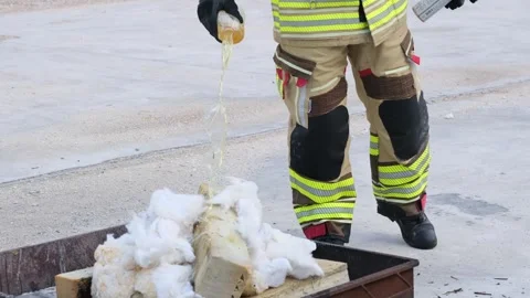 Firefighter Pouring Flammable Liquid for Fire Drill Stock Footage 301051902