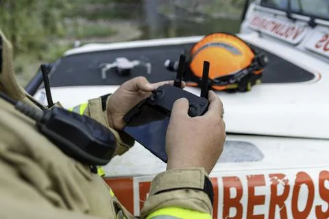 Firefighter preparing drone to make it fly. Stock Photos