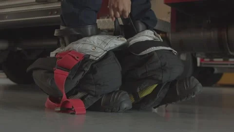 Firefighter Preparing Gear Before Heading Out of Fire Department Slow Motion Stock Footage 244740619