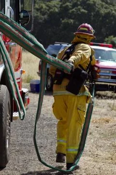 Firefighter pulling hose Stock Photos
