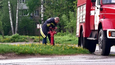 Firefighter, pulls a fire hydrant out of the sewer. Stock Footage 109388623