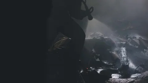 Firefighter puts out fire Stock Footage 76850426