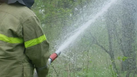 A firefighter puts out a fire in the forest Stock Footage 300765346