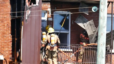 Firefighter removing stoff wich is falling on a colleague Stock Footage 90337448