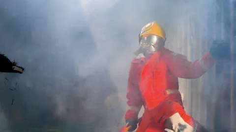 Firefighter Rescue training in fire fighting extinguisher. Firefighter fighting  Stock Footage 208836606