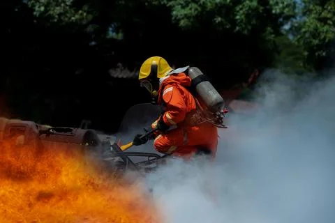 Firefighter Rescue training to stop burning flame, Fireman wear hard hat an.. Stock Photos