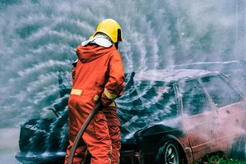 Firefighter Rescue training to stop burning flame, Fireman wear hard hat an.. Stock Photos