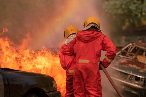 Firefighter Rescue training to stop burning flame, Fireman wear hard hat an.. Stock Photos