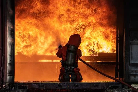 Firefighter Rescue training to stop burning flame, Fireman wear hard hat an.. Stock Photos