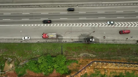 Firefighter Responds to Car Fire on Highway Stockbeeldmateriaal 337330507