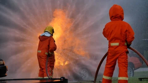 Firefighter safety protect danger from fire flame heat using water equipment. Stock Footage 112603897