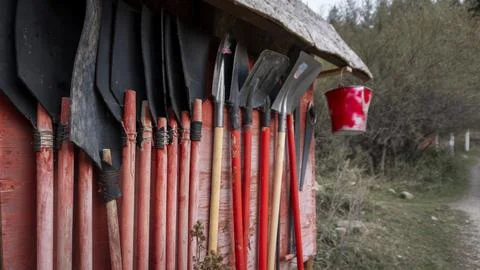 Firefighter shield with fire extinguishing tools Stock Photos