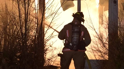 Firefighter Silhouetted in Fire Stock Footage 59868116