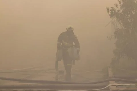 Firefighter in the smoke. Stock Photos