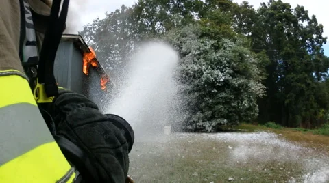 Firefighter sparying foam Stock Footage 68959462