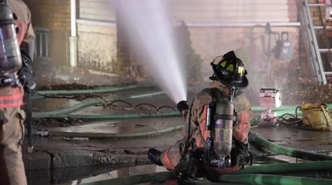 Firefighter Sprays Water on Fire Stock Footage 59867745