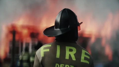 Firefighter Standing in Front of Burning House Surrounded by Flames 스톡 동영상 336516097