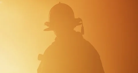 Firefighter standing in front of fire Stock Footage 91144233