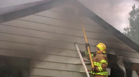 Firefighter takes off house shards Stock Footage 46970666