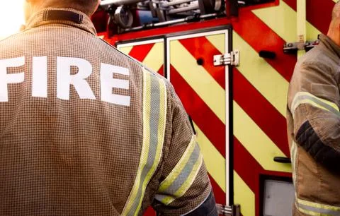 Firefighter team - firemen equipped in emergency services firefighting uniform Stock-Fotos