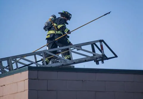 Firefighter on top of building Stock Photos