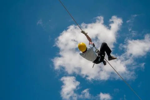 Firefighter training on wire  and blue sky and clouds Stock Photos